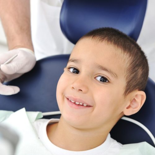 child+in+a+dentist+chair+smiling
